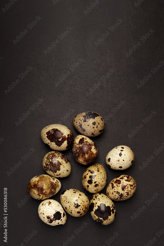 Quail eggs on black background. Healthy food concept. Top view Quail eggs on black background. Healthy food concept. Top view