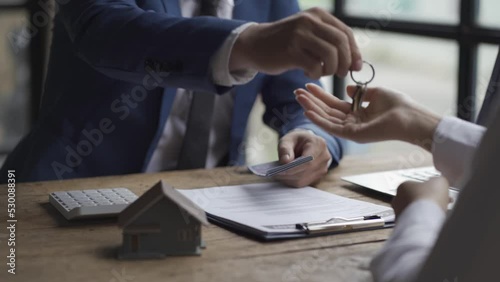 Real estate sales ideas, finance introduction, interest rates on installments, handshaking and handing over the keys at the table.