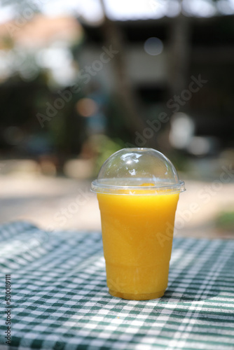 Mango smoothie milk shake with take out glass