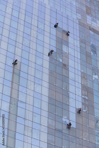 Wallpaper Mural Workers peeling film off glass that has just been installed on a skyscraper. Torontodigital.ca