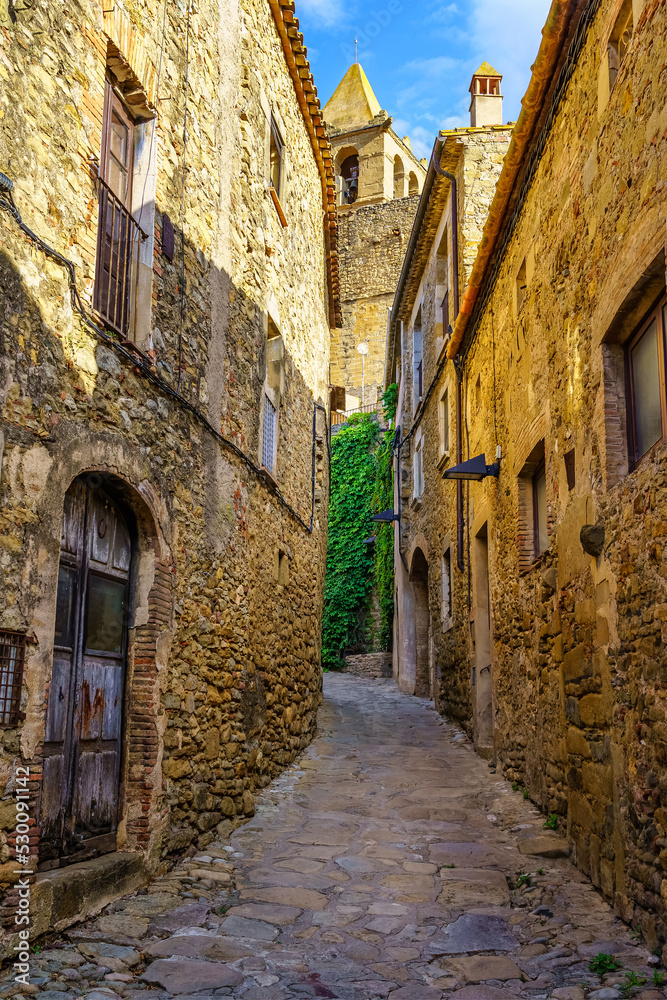 Narrow alleys with medieval stone houses in the old village of Madremanya, Girona.