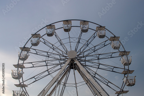 looking up at ferris wheel in early morning light
