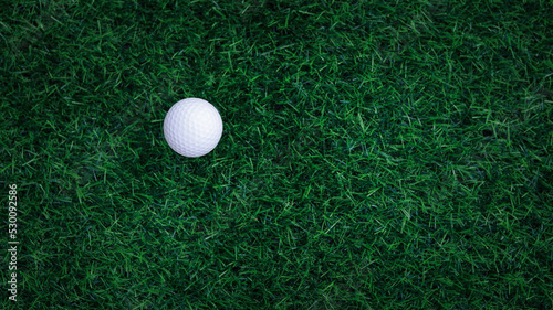 Golf ball close up on tee grass on blurred beautiful landscape of golf background. Concept international sport that rely on precision skills for health relaxation. top view.