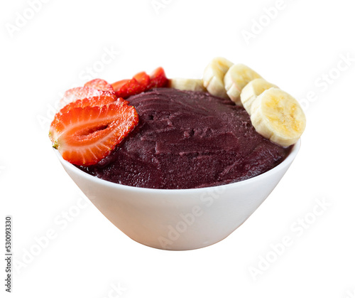 Brazilian frozen açai berry ice cream bowl with strawberries and bananas in front. isolated. Summer menu front view