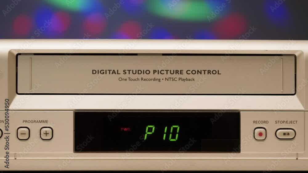 Old video recorder close-up, VHS. Retro player, vintage video cassette broadcasting on neon background, audio tape, disco party. Old video recorder close-up, VHS. Retro player, vintage video cassette broadcasting on neon background, audio tape, disco party.