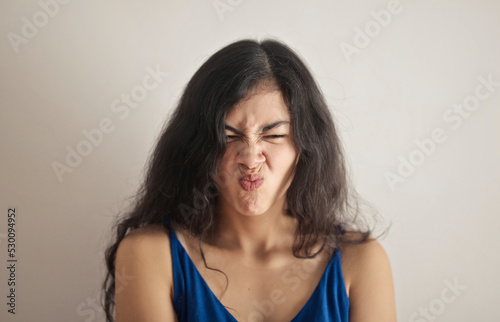 portrait of young woman with expression of disgust