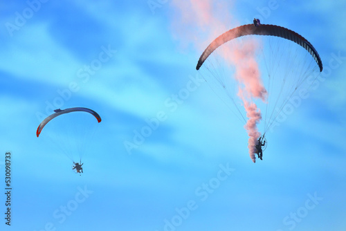 Paraglider flying against the blue sky with clouds, outdoor activities, extreme sports, extreme sport, paraglider flying in the sun