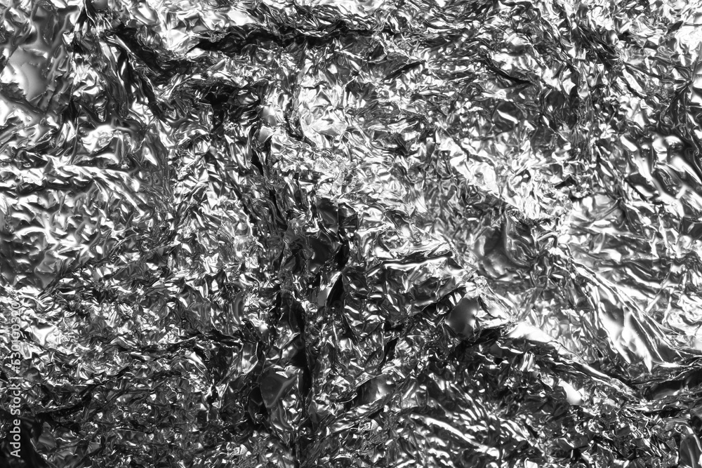 Obraz premium Crumpled silver foil as background, closeup view