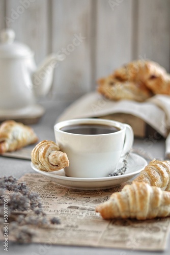 Cup of coffee and croissants. 