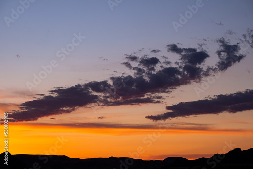 Sunset over the mountains. Red sunset in the sky with clouds. © Сергей Дудиков