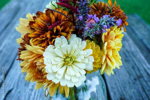 Photography Close up of a bouquet of garden picked flowers in a glass jar