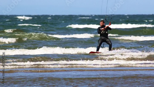 Kitesurfer riding in the waves