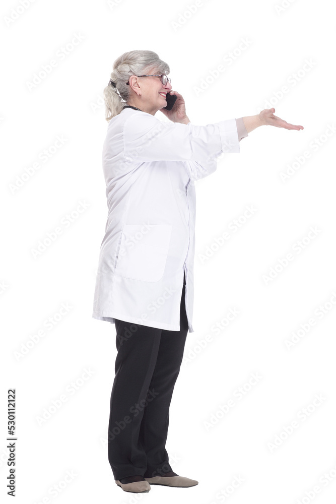 female doctor with a smartphone pointing at an ad on a white wall . female doctor with a smartphone pointing at an ad on a white wall .