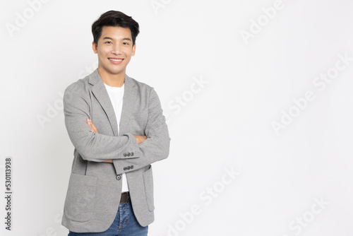 Young Asian businessman smilling with arms crossed isolated on white background