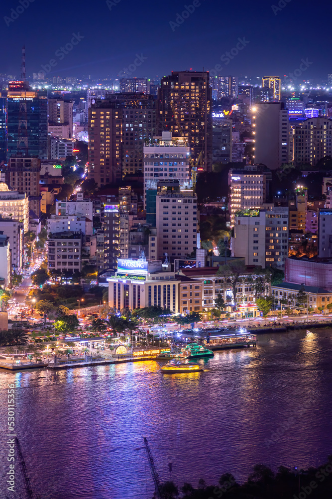 Aerial view of Bitexco Tower, buildings, roads, Thu Thiem 2 bridge and Saigon river in Ho Chi Minh city - Far away is Landmark 81 skyscraper. Travel concept.