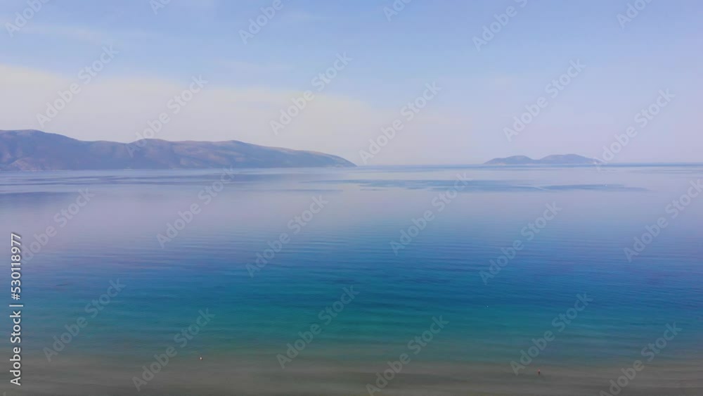 Ocean beach sunsets beautiful sky Aerial view drone camera. Island on horizon. Vlore, Albania Ocean beach sunsets beautiful sky Aerial view drone camera. Island on horizon. Vlore, Albania