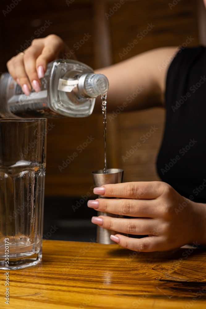 A bartender prepares a cocktail at the restaurant bar
