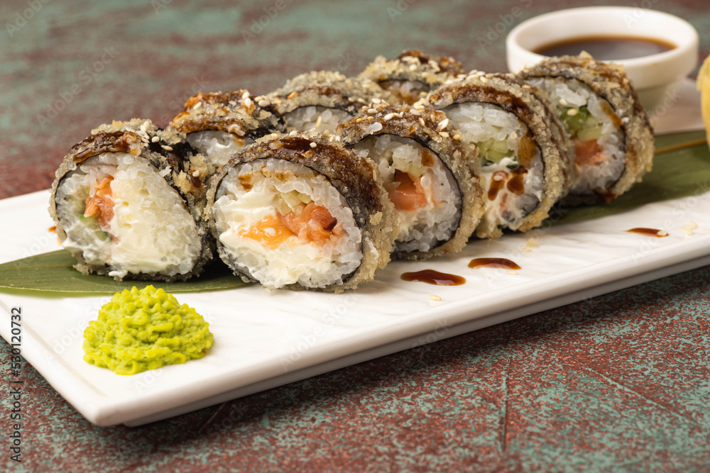 Sushi, rolls, sushi with fish on a textured background, side view Sushi, rolls, sushi with fish on a textured background, side view