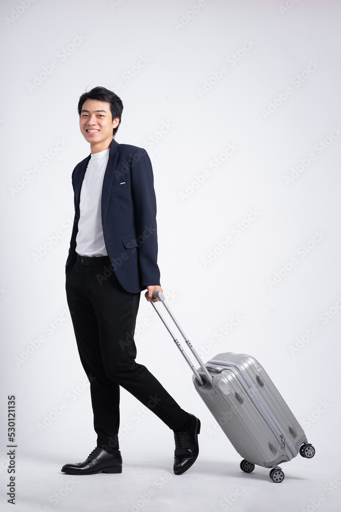 Young business man wearing a suit posing on a white background
