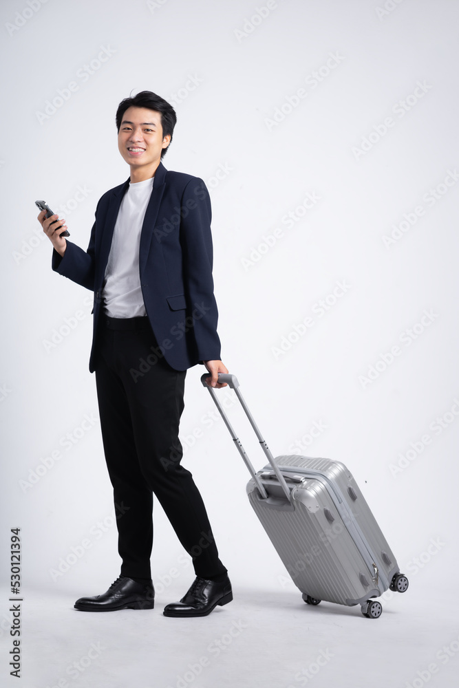 Young business man wearing a suit posing on a white background Young business man wearing a suit posing on a white background