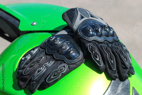 Black protective gloves for a motobiker with plastic inserts. photo