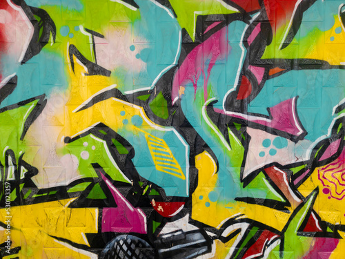 Part of a bright multi-colored wall graffiti. Youth art culture.