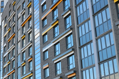Windows of a multi-storey residential building. Modern urban abstract background.