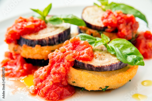 Melenzane mbuttunate, ricetta tradizionale di melanzane ripiene e condite con sugo di pomodoro, cibo italiano  photo