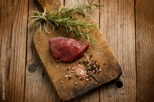 raw tenderloin with ingredients over cutting board #530129974