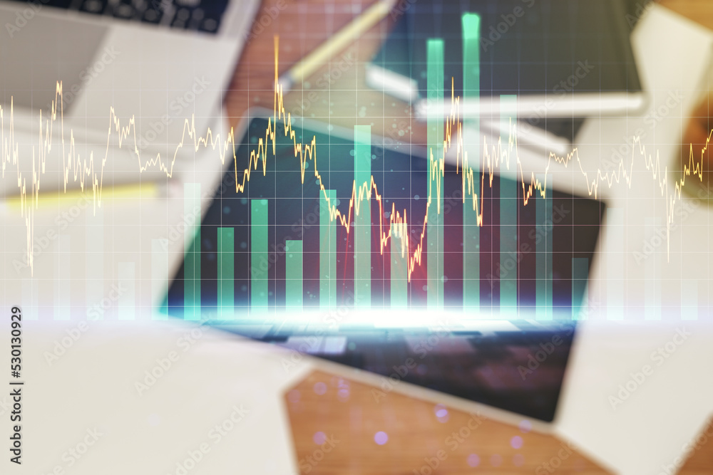 Double exposure of abstract creative financial diagram and modern digital tablet on background, banking and accounting concept Double exposure of abstract creative financial diagram and modern digital tablet on background, banking and accounting concept