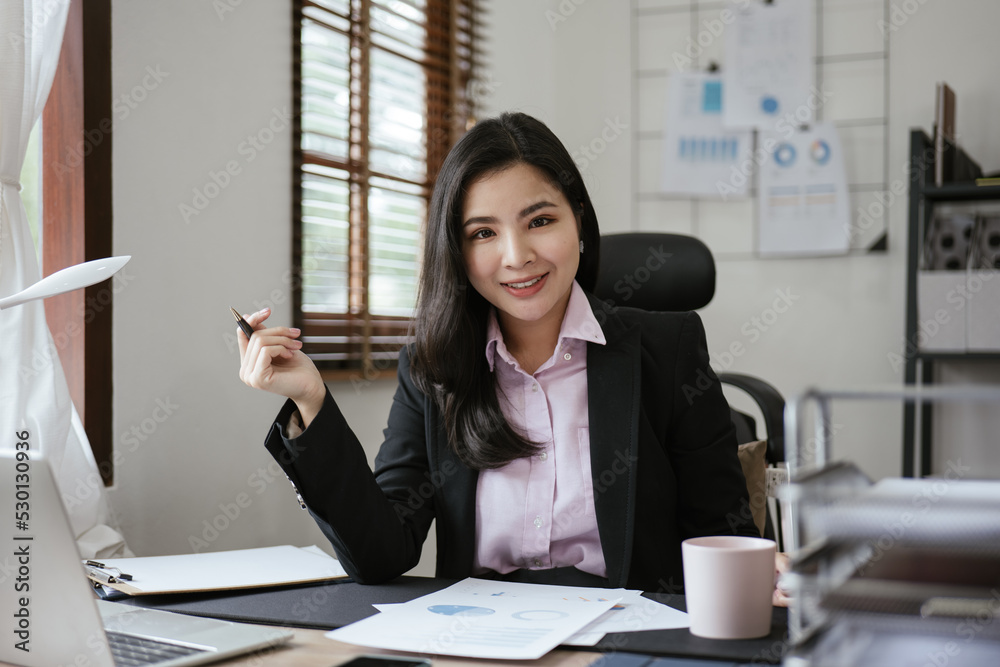 Young business women working on laptop with happy and smile face on office spec. Young business women working on laptop with happy and smile face on office spec.