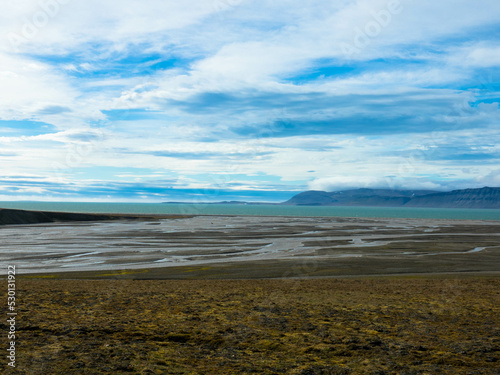 Snowless arctic landscape. Seen on Barentsoya island. Spitsbergen, Svalbard, Norway. Tourism and vacation concept. photo