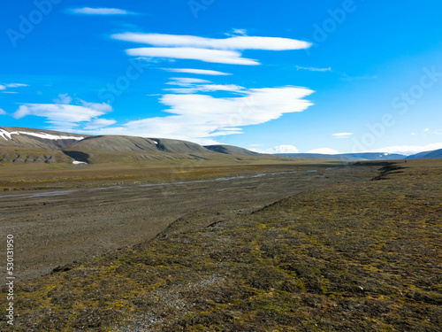 Snowless arctic landscape. Seen on Barentsoya island. Spitsbergen, Svalbard, Norway. Tourism and vacation concept. photo