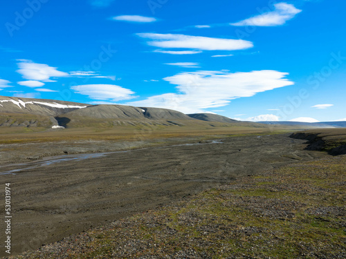 Snowless arctic landscape. Seen on Barentsoya island. Spitsbergen, Svalbard, Norway. Tourism and vacation concept. photo
