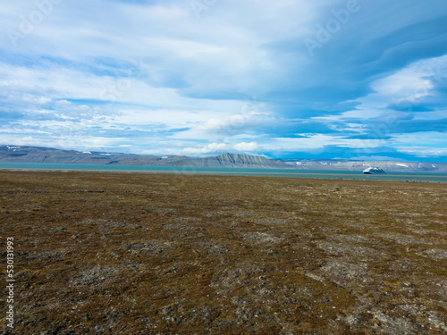 Snowless arctic landscape. Seen on Barentsoya island. Spitsbergen, Svalbard, Norway. Tourism and vacation concept. photo