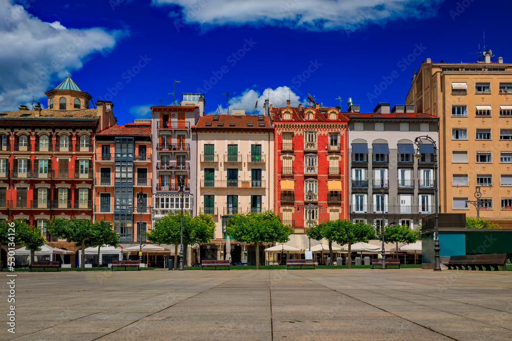 Ornate facades of buildings on Historic Plaza del Castillo with restaurants and cafes in Old Town Pamplona, Spain famous for running of the bulls
