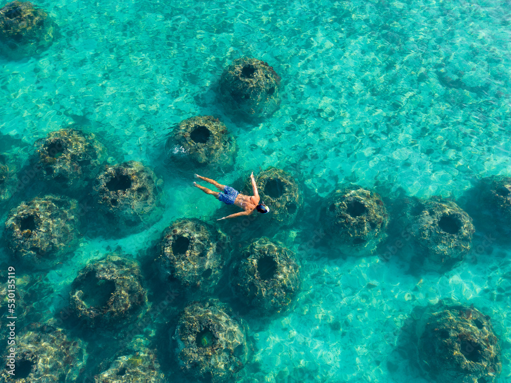 Fototapeta premium Man Snorkelling in the Sea. High quality photo. Aerial View from above.