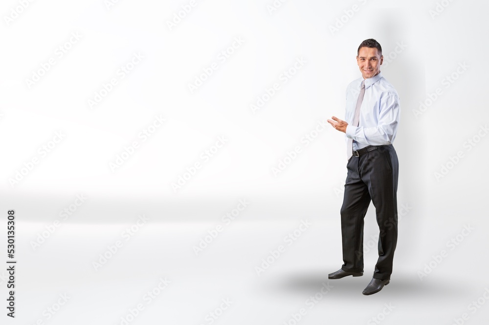 Young businessman standing and posing on background Young businessman standing and posing on background