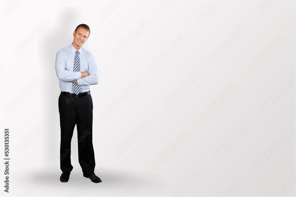 Young businessman standing and posing on background Young businessman standing and posing on background