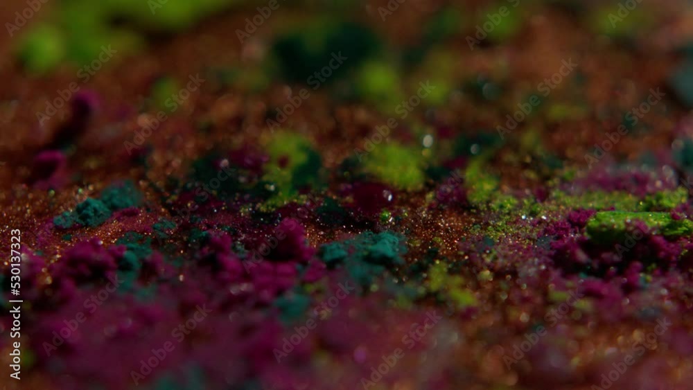 super closeup multicolor powder getting wet in slow motion super closeup multicolor powder getting wet in slow motion