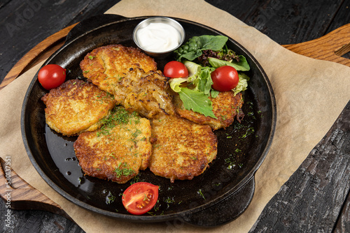 delicious potato fritters on a wooden table 