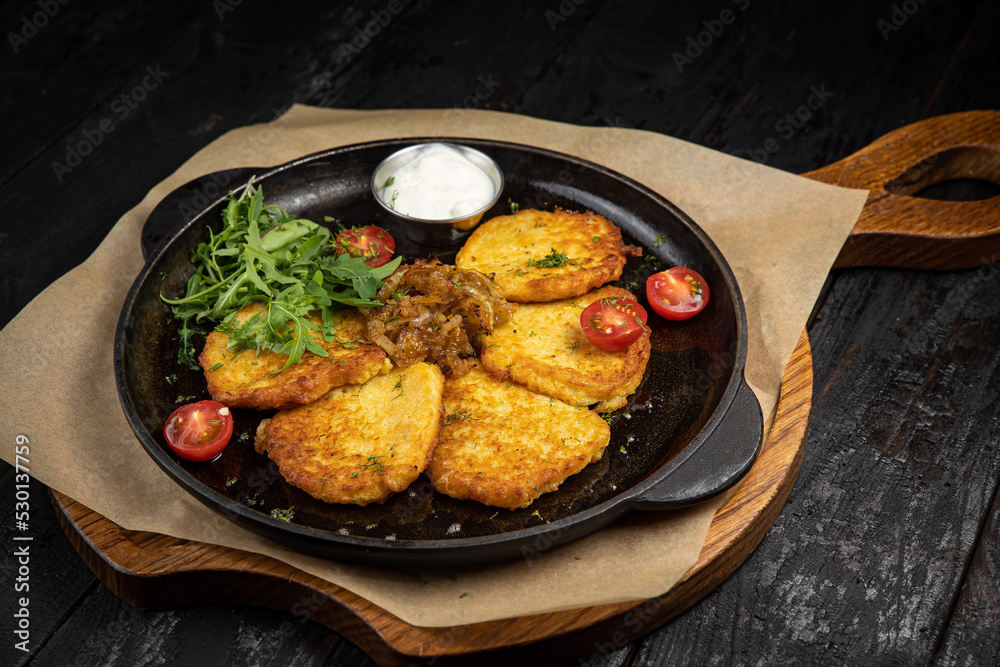 delicious potato fritters on a wooden table
delicious potato fritters on a wooden table
