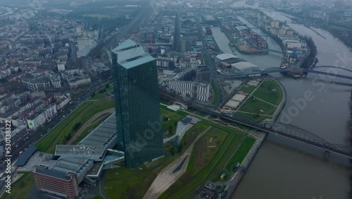 Elevated shot of futuristic European Central Bank skyscraper. bridge over river in city and harbour in background. Frankfurt am Main, Germany photo