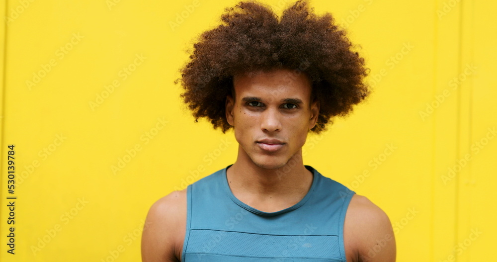 Young african american mixed rac man changing emotion in yellow background, from serious expression to feeling happy smiling Young african american mixed rac man changing emotion in yellow background, from serious expression to feeling happy smiling