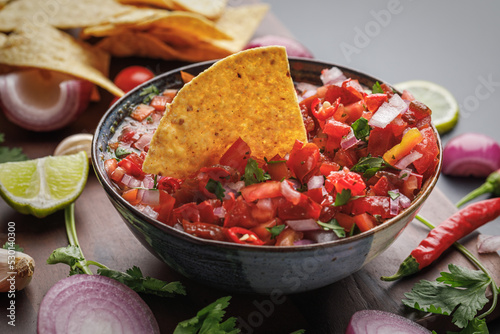 Tortilla chips and fresh salsa made with homegrown ingredients of tomatoes, red onions, garlic, chili peppers, cilantro and lime