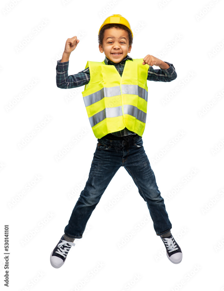 building, construction and profession concept - smiling little boy in yellow safety vest and helmet jumping over white background building, construction and profession concept - smiling little boy in yellow safety vest and helmet jumping over white background