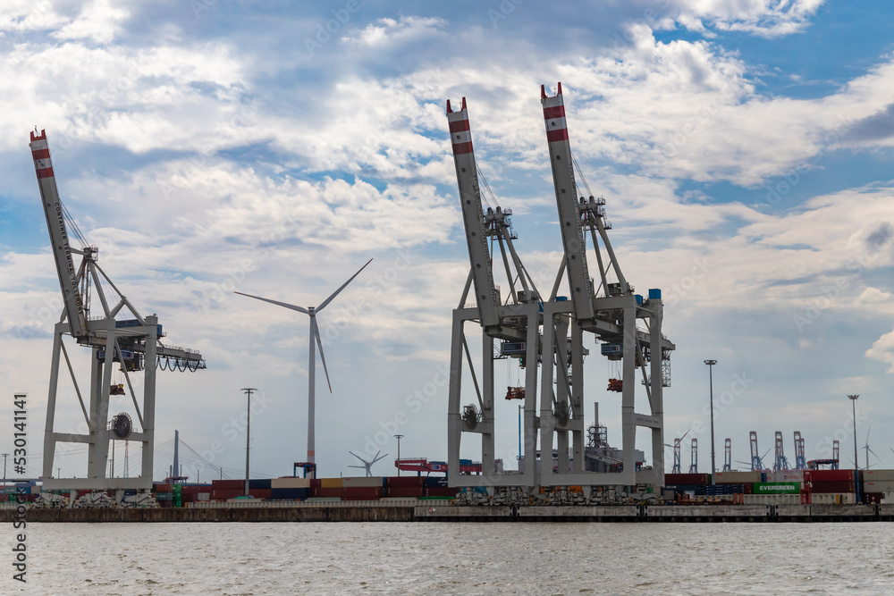 Hamburg, Germany - July 25, 2022, Alster - Port with shipyards, cranes, logistic facilities and messengers from Hamburg in Germany