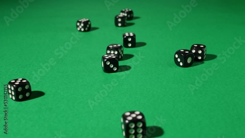 Hands in white gloves pour out a lot of black dice on a green gaming table. White Dice Transition, devil's bones, Dice Transition, Casino dice, Falling Dice