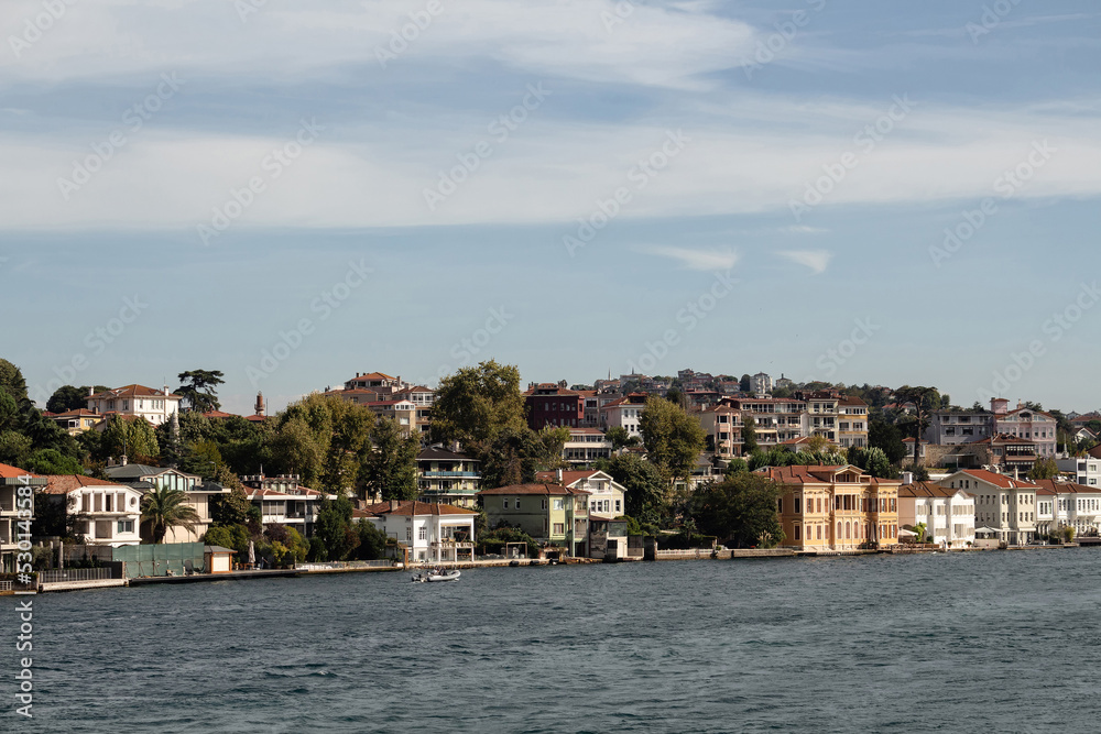 View of historical, traditional mansions by Bosphorus in Anadolu Hisari area of Asian side of Istanbul. It is a sunny summer day. Beautiful travel scene.