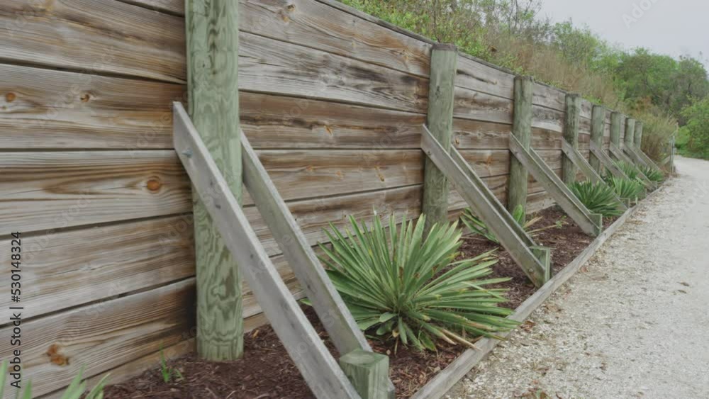 Wooden fence along driveway with yucca plants at beach home Wooden fence along driveway with yucca plants at beach home